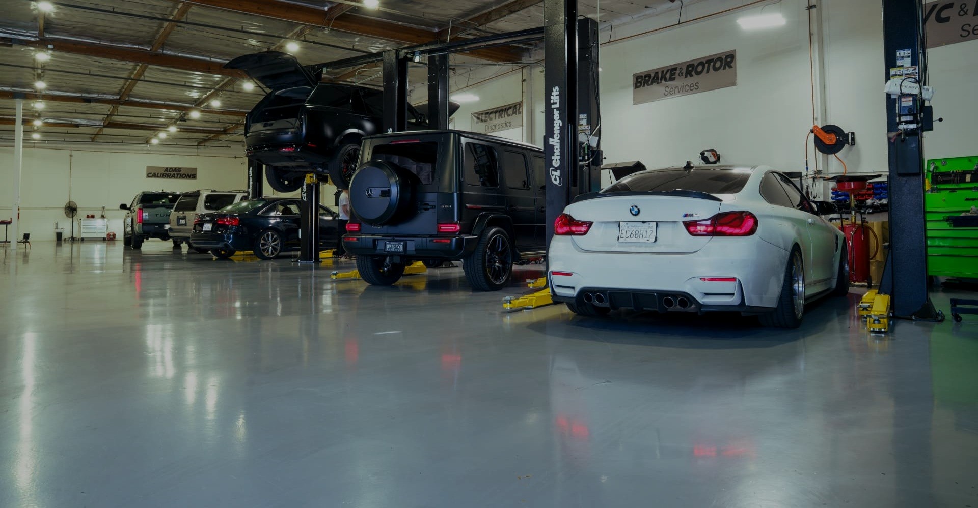 PC Automotive shop floor with vehicles on hydraulic lifts